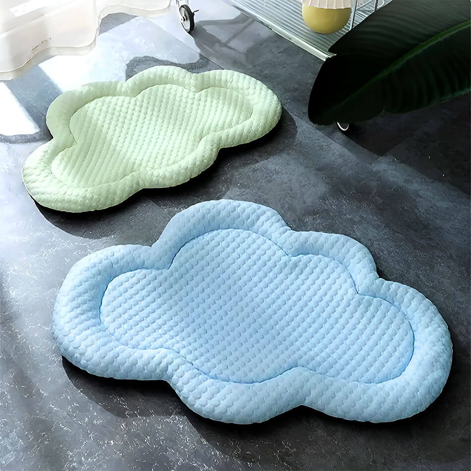 Two Soft Cloud Frenchie Cooling Mats on the black marble floor