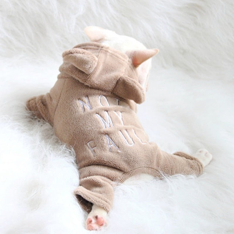 Cream French Bulldog puppy wearing brown SnugFeel™ French Bulldog Jumpsuit while laying on the furry blanket